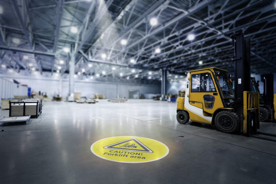 Clarity Visual Management LED projected floor marking solution advising "Caution! Forklift area"